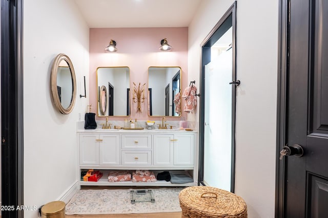 full bathroom featuring double vanity and a sink