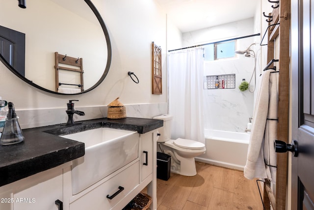 full bath featuring toilet, wood finished floors, vanity, and shower / tub combo with curtain