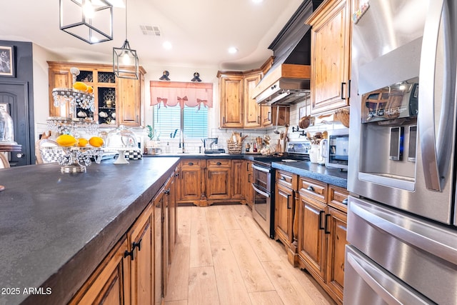 kitchen with tasteful backsplash, visible vents, dark countertops, appliances with stainless steel finishes, and light wood-style floors