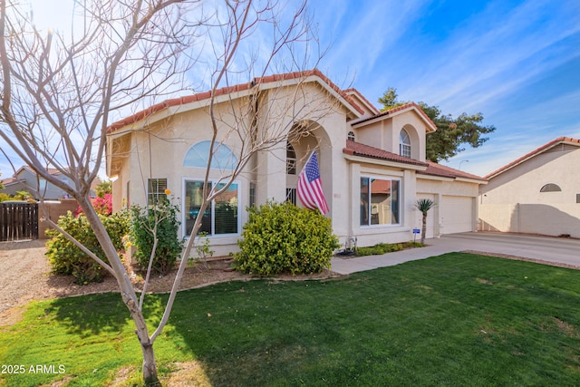 mediterranean / spanish house with a garage and a front lawn