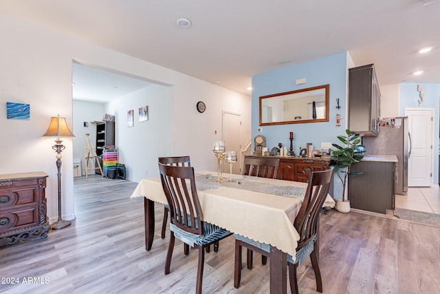 dining room with recessed lighting, baseboards, and light wood finished floors