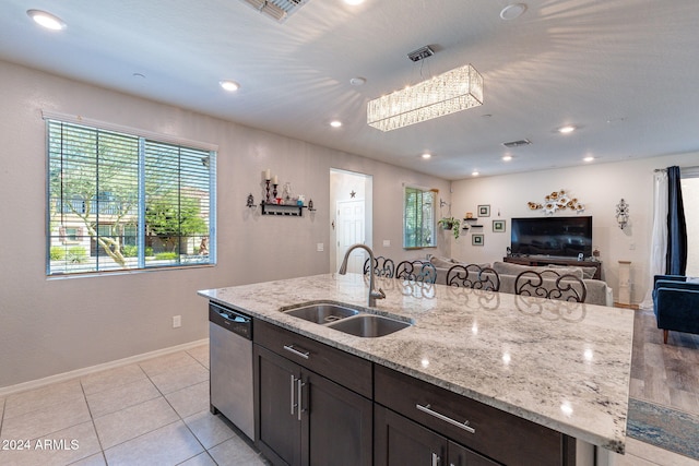 kitchen with dark brown cabinets, sink, plenty of natural light, and dishwasher