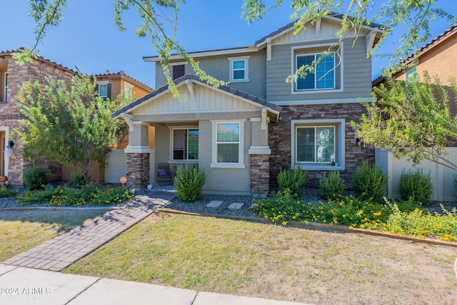 craftsman-style house with covered porch and a front yard