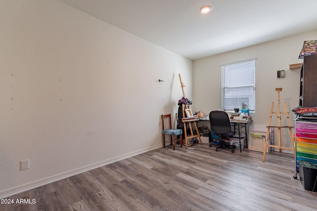 office space featuring baseboards and wood finished floors