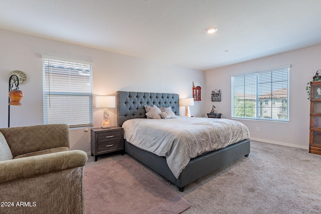 bedroom with baseboards and light carpet