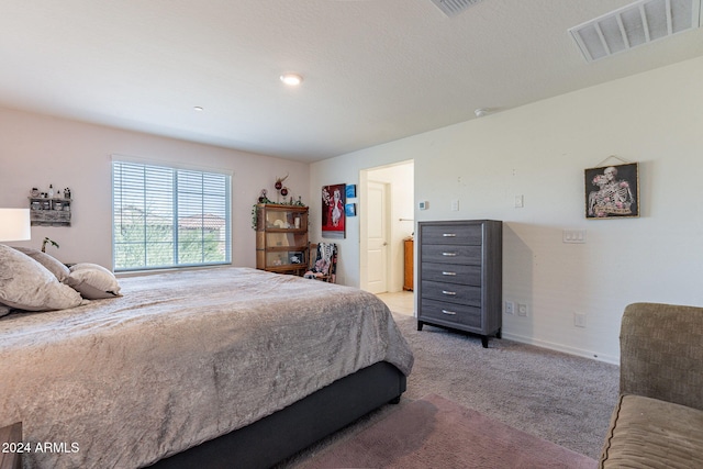 carpeted bedroom featuring ensuite bathroom