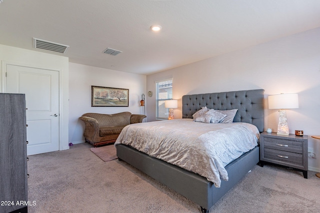 carpeted bedroom with baseboards and visible vents
