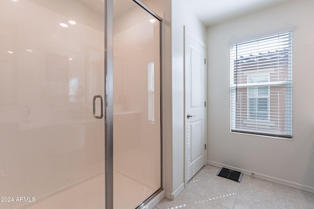 bathroom with visible vents, baseboards, tile patterned flooring, and a shower stall