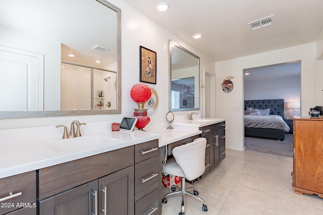 bathroom featuring vanity, visible vents, tile patterned flooring, and a stall shower
