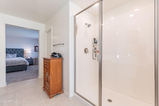 bathroom with a shower with door and tile patterned flooring