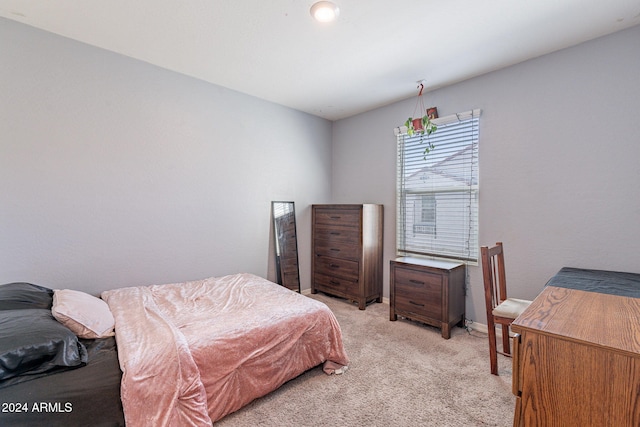 bedroom with baseboards and light carpet