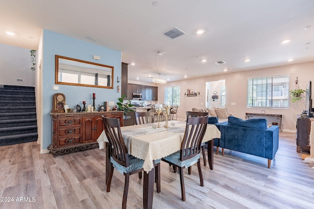 dining space with recessed lighting, visible vents, light wood finished floors, and stairway