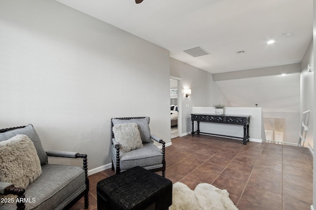 sitting room featuring dark tile patterned floors