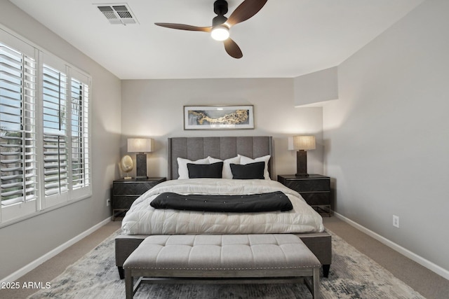 bedroom with ceiling fan, carpet flooring, and multiple windows