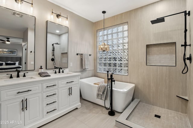 bathroom featuring vanity and separate shower and tub