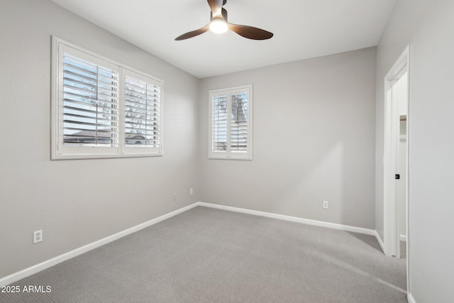 spare room with ceiling fan and carpet flooring