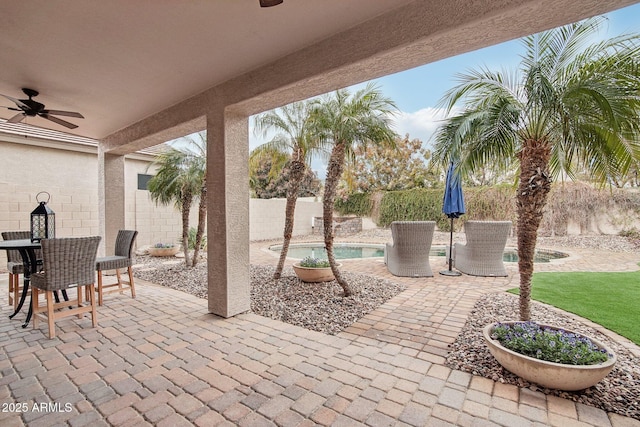 view of patio with ceiling fan and a fenced in pool