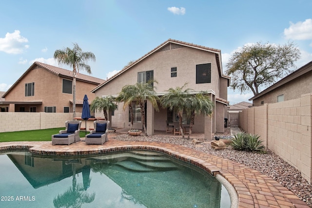 back of property featuring an outdoor living space, a fenced in pool, and a patio