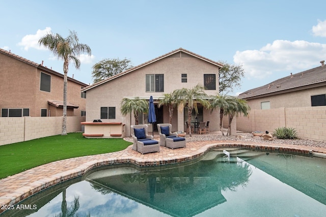 view of swimming pool featuring a patio and a yard