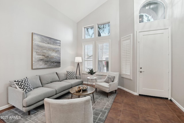 tiled living room with high vaulted ceiling