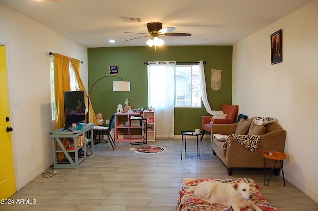 sitting room with ceiling fan and light hardwood / wood-style floors