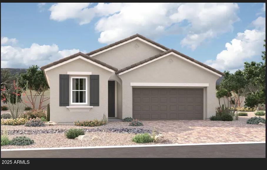 ranch-style home featuring a tiled roof, decorative driveway, an attached garage, and stucco siding