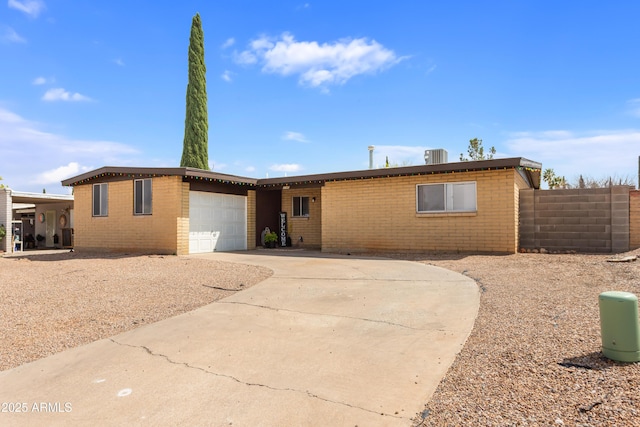 1140 Ocotillo Dr, Sierra Vista, AZ 85635 - ranch-style house featuring driveway, brick siding, fence, and an attached garage