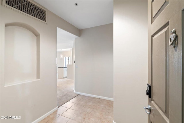 corridor featuring light tile patterned floors