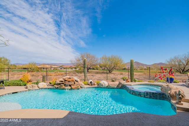 view of pool with a mountain view, an in ground hot tub, fence, and a fenced in pool