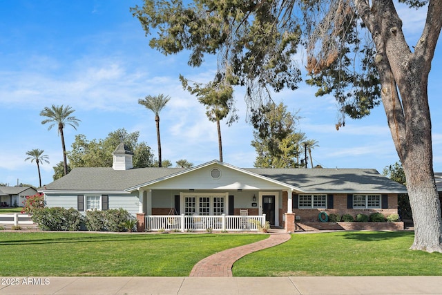 ranch-style home featuring a porch and a front yard