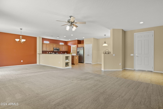 unfurnished living room featuring light colored carpet and ceiling fan with notable chandelier