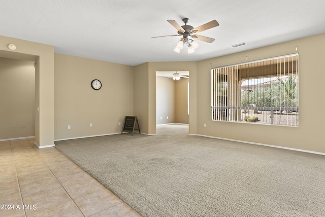 carpeted spare room with ceiling fan