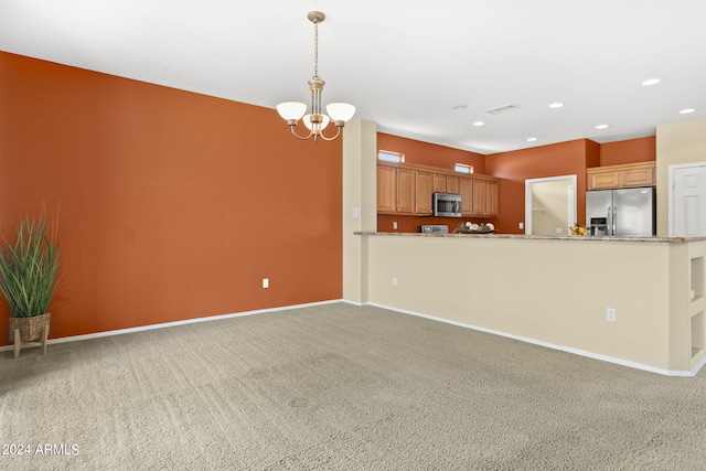 kitchen featuring light carpet, an inviting chandelier, and appliances with stainless steel finishes