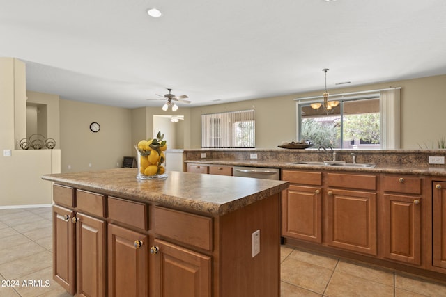 kitchen with a kitchen island, ceiling fan with notable chandelier, dishwasher, sink, and light tile patterned flooring