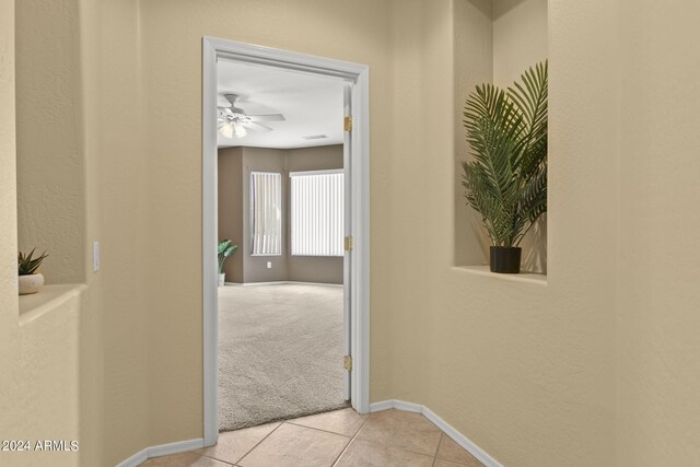 corridor featuring light tile patterned floors