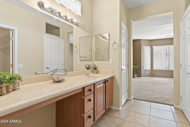 bathroom with ceiling fan, tile patterned flooring, and vanity