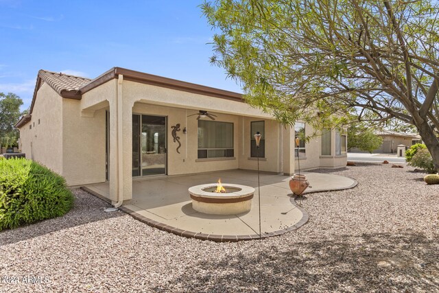 rear view of property featuring a patio area, a fire pit, and ceiling fan