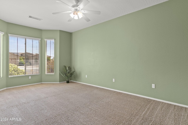 carpeted empty room featuring ceiling fan