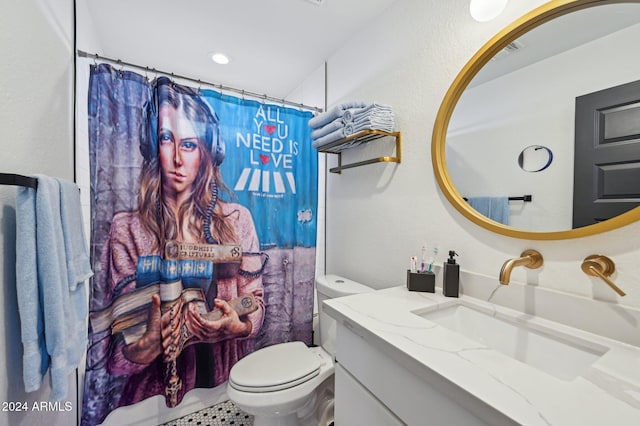 bathroom featuring toilet, vanity, and a shower with curtain
