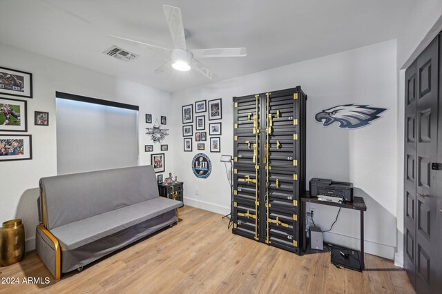 sitting room featuring ceiling fan, wood finished floors, and baseboards
