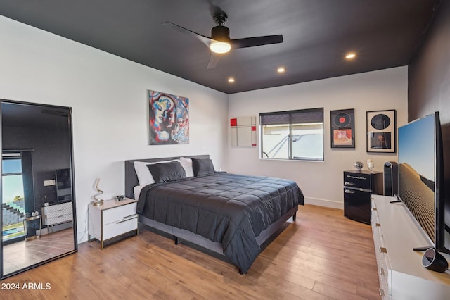 bedroom with light wood finished floors, baseboards, recessed lighting, and a ceiling fan