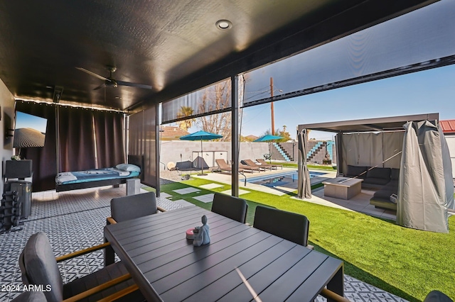 view of patio / terrace with a ceiling fan and outdoor dining space