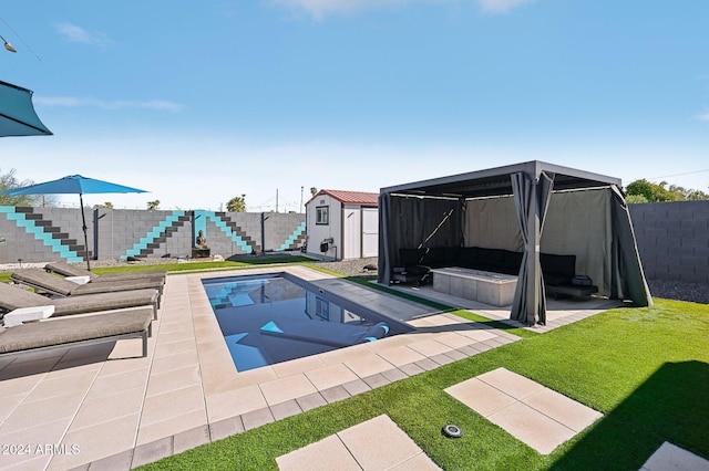 view of swimming pool featuring a storage shed, an outdoor structure, and a patio