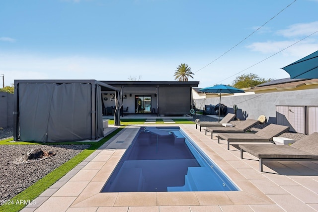 view of swimming pool with fence and a patio