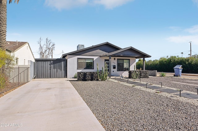 view of front of home featuring fence, driveway, and stucco siding