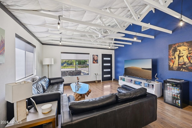 living room featuring wood finished floors, track lighting, and baseboards