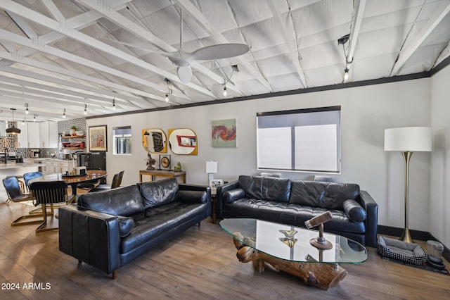 living area featuring dark wood-style floors and beam ceiling