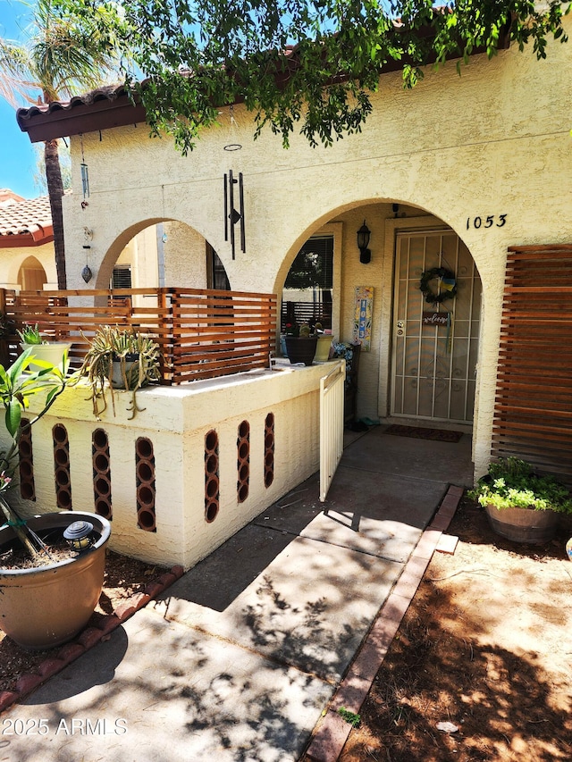 5136 E Evergreen St Unit 1053, Mesa, AZ 85205 - view of exterior entry featuring stucco siding and covered porch