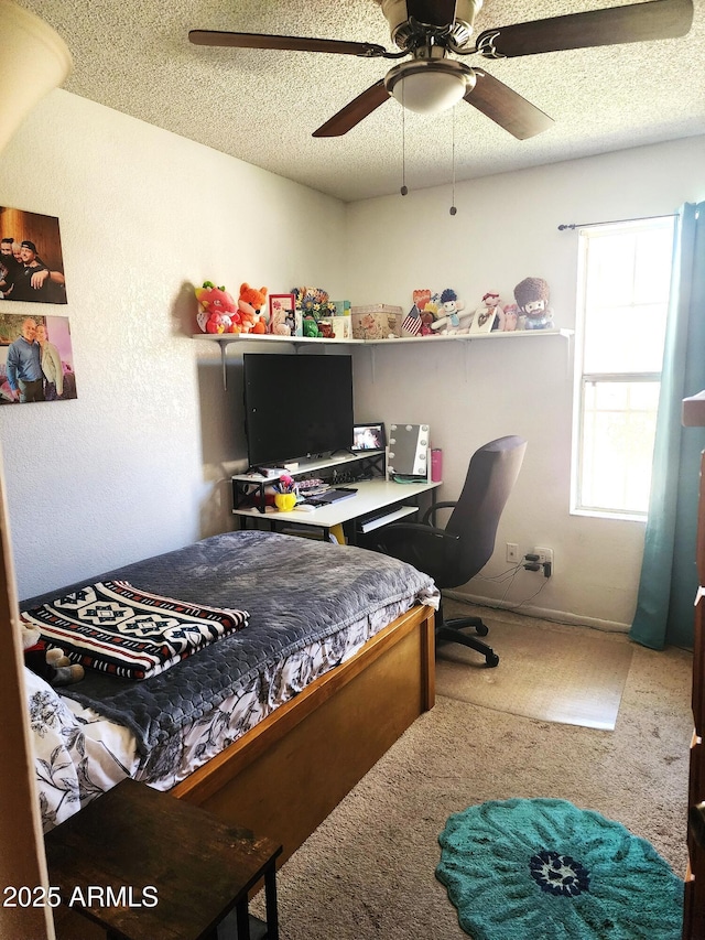 5136 E Evergreen St Unit 1053, Mesa, AZ 85205 - carpeted bedroom featuring a textured ceiling, a desk, and a ceiling fan