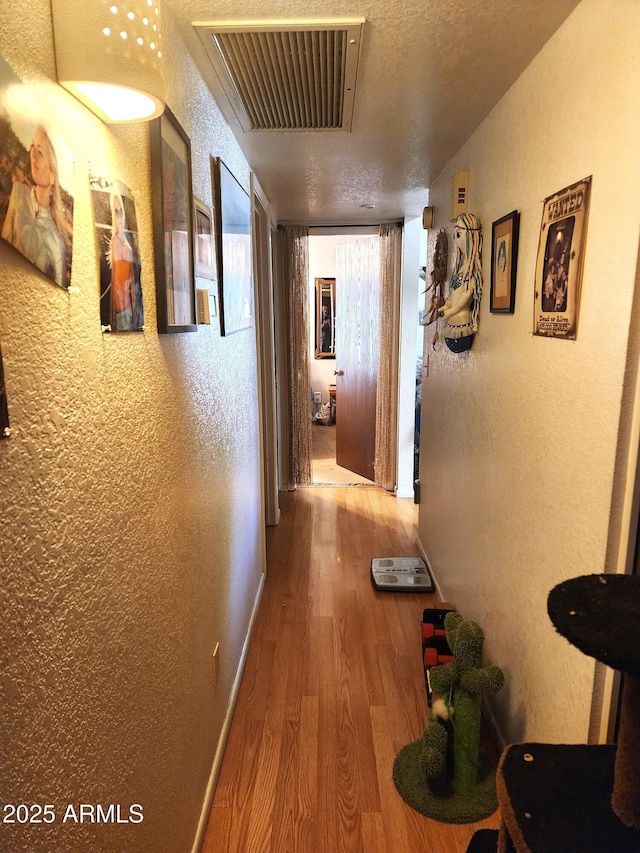 5136 E Evergreen St Unit 1053, Mesa, AZ 85205 - hallway with wood finished floors and a textured wall